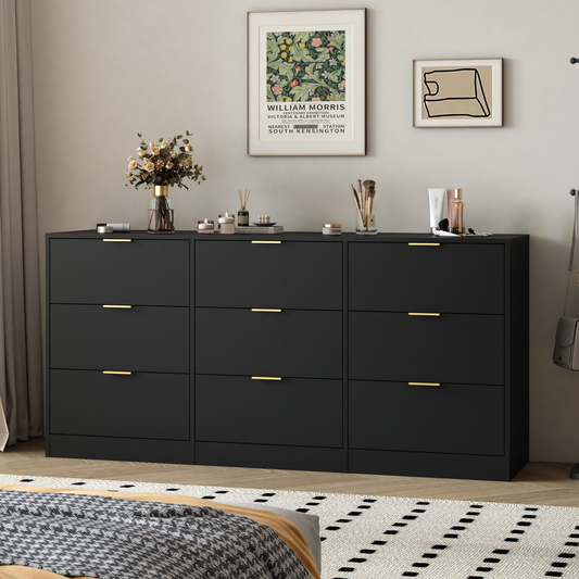 Black dresser with gold handles in a bedroom setting with framed artwork on the wall.