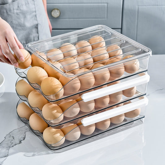 Clear egg storage container with eggs on a kitchen counter