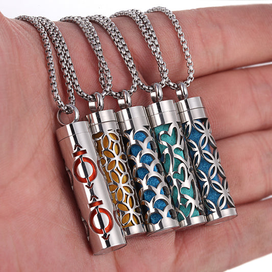 Five metallic necklaces with different designs held in a hand.