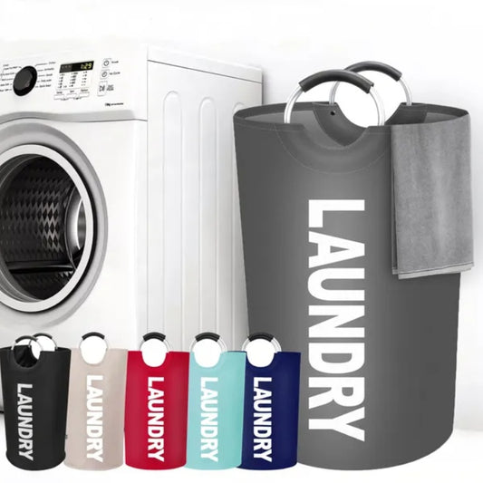 Gray laundry basket with 'LAUNDRY' text next to a washing machine.