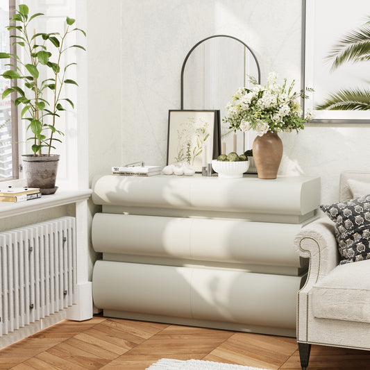 Modern living room with a white dresser, mirror, and decor items.