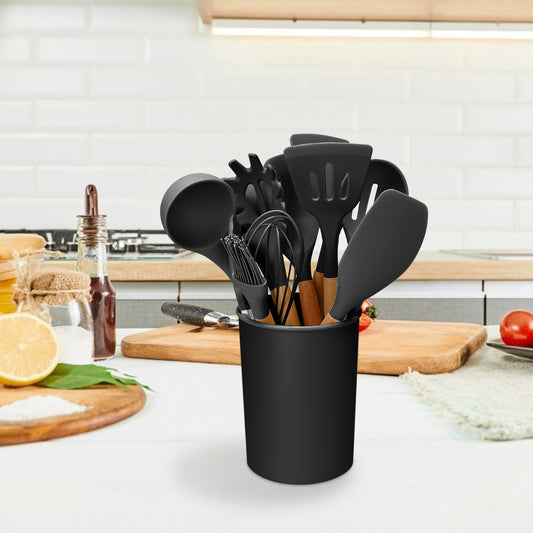 Set of black kitchen utensils in a holder on a kitchen counter.