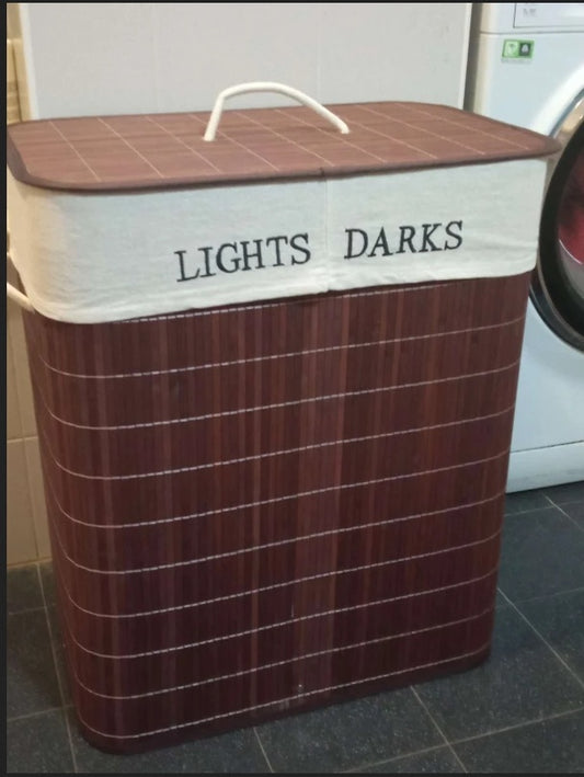 Two-tone laundry basket labeled 'Lights' and 'Darks' in a laundry room.