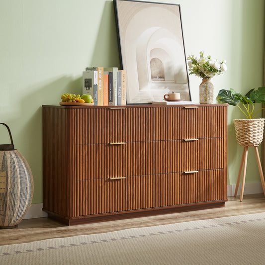 Wooden dresser with decorative items against a light green wall